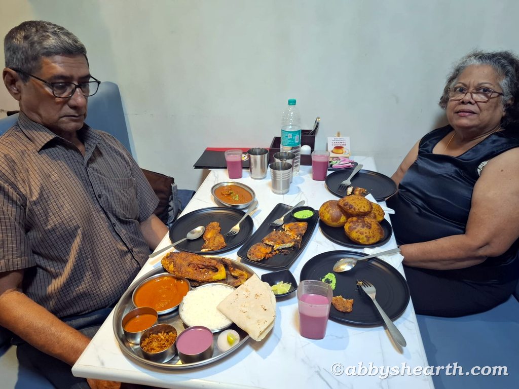 My parents eating a rawas thali, surmai fry and other fish dishes at Aplo Konkan.