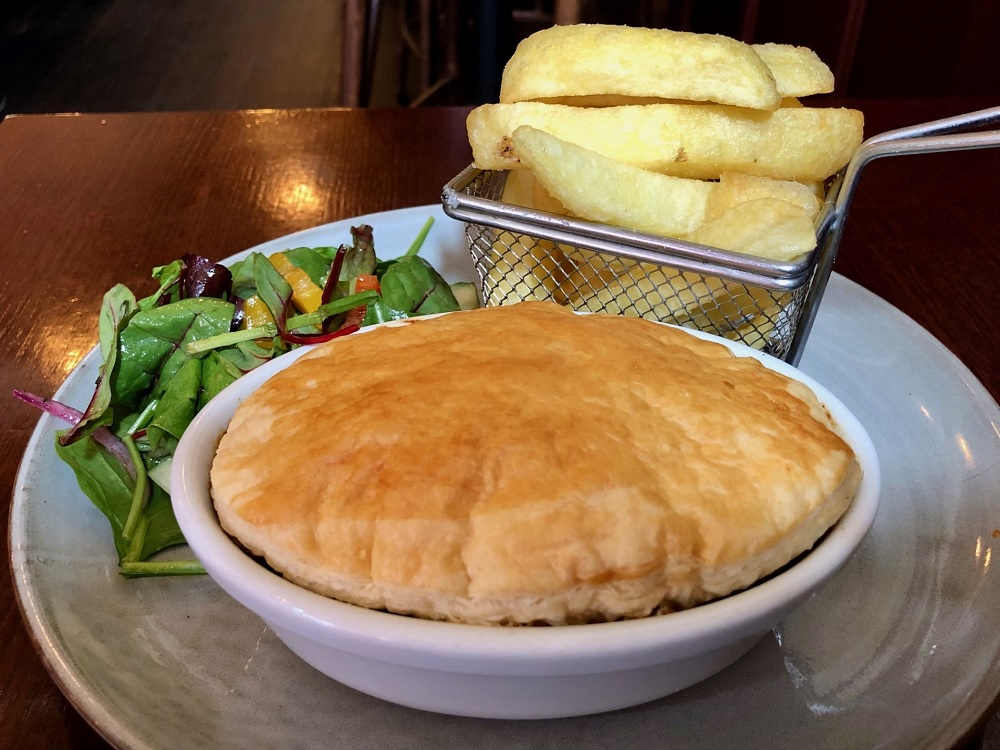 Beef and guinness pie with chips and a side salad.