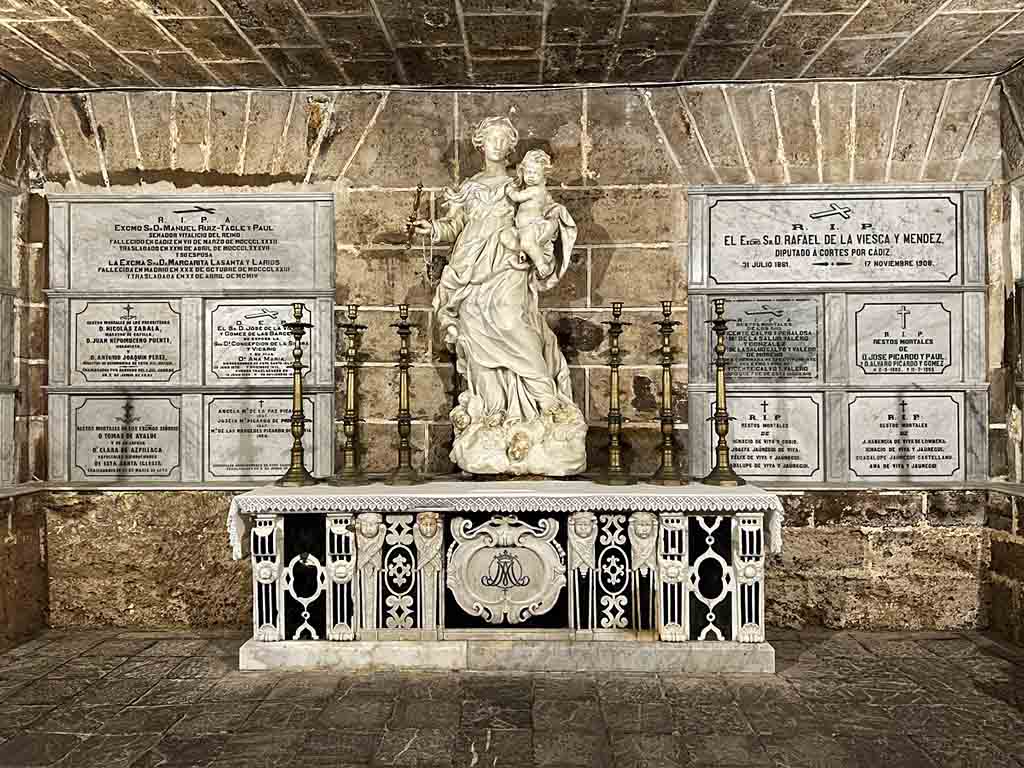 Stone Crypt with Mother Mary and Jesus statue on it.