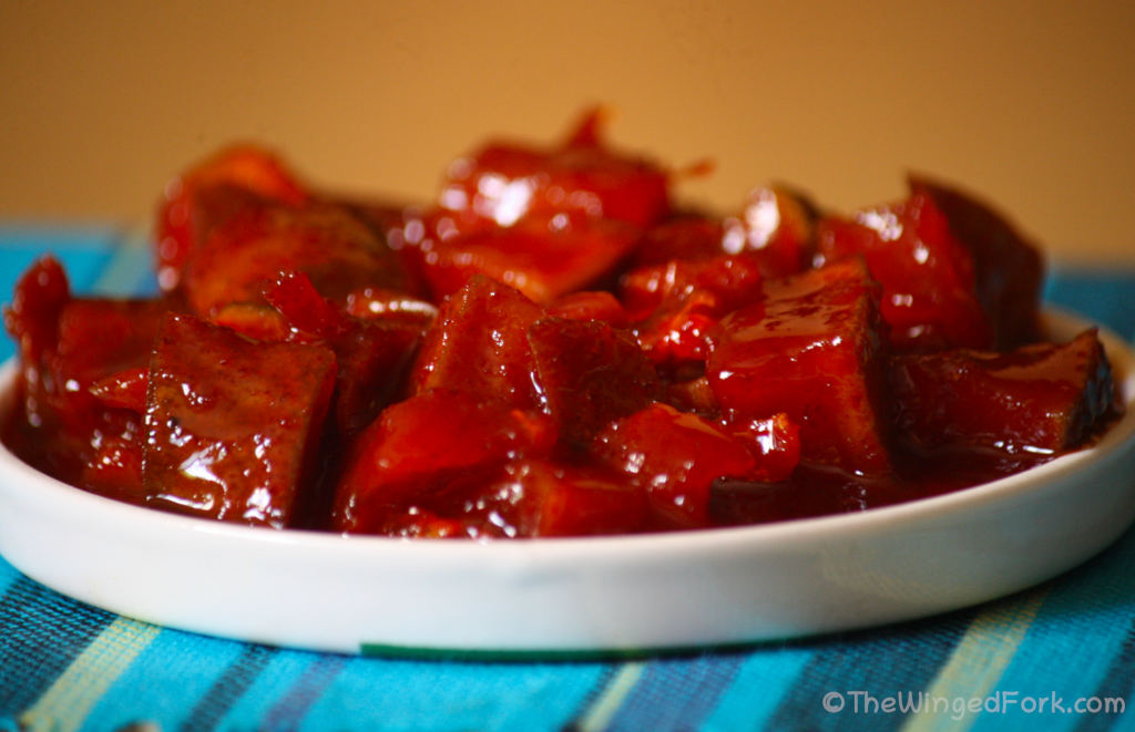 Mango pickle in a white dish.