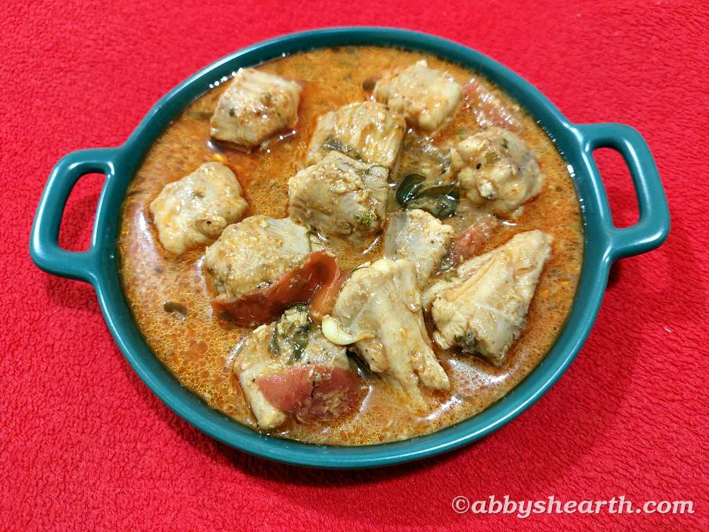 Top view of milk shark curry in a green dish.
