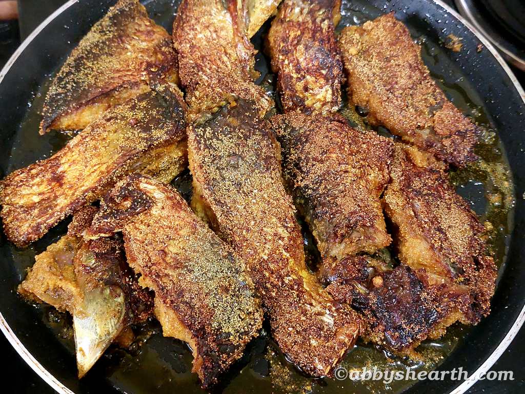 The other side of the palla or illish fish frying in the pan.