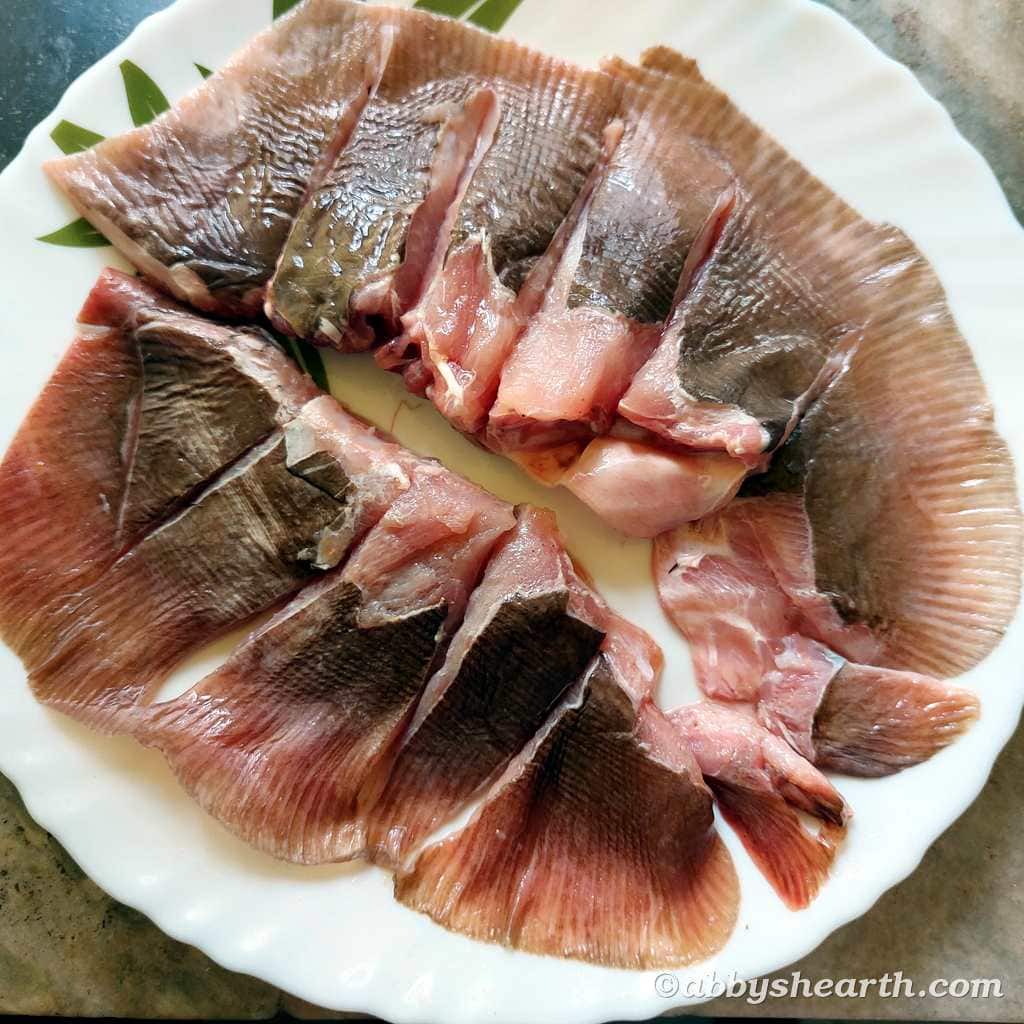 One ray fish (pakat) cut into pieces in a plate.
