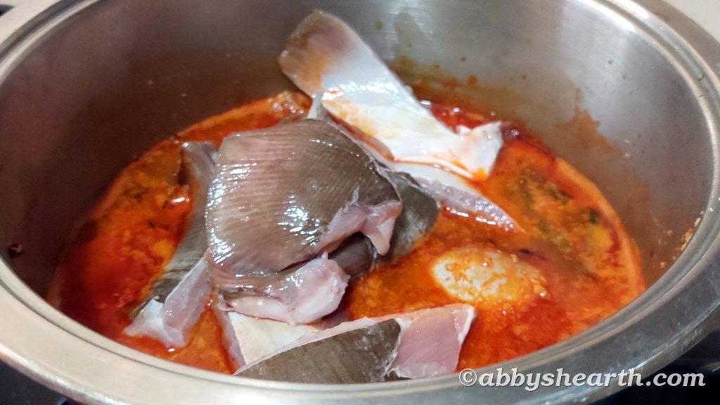 Pakat (ray/skate fish) pieces added to the curry.