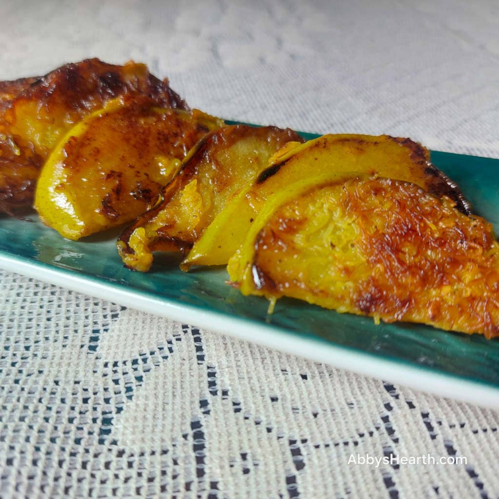 Slices of fried pears in a green platter.