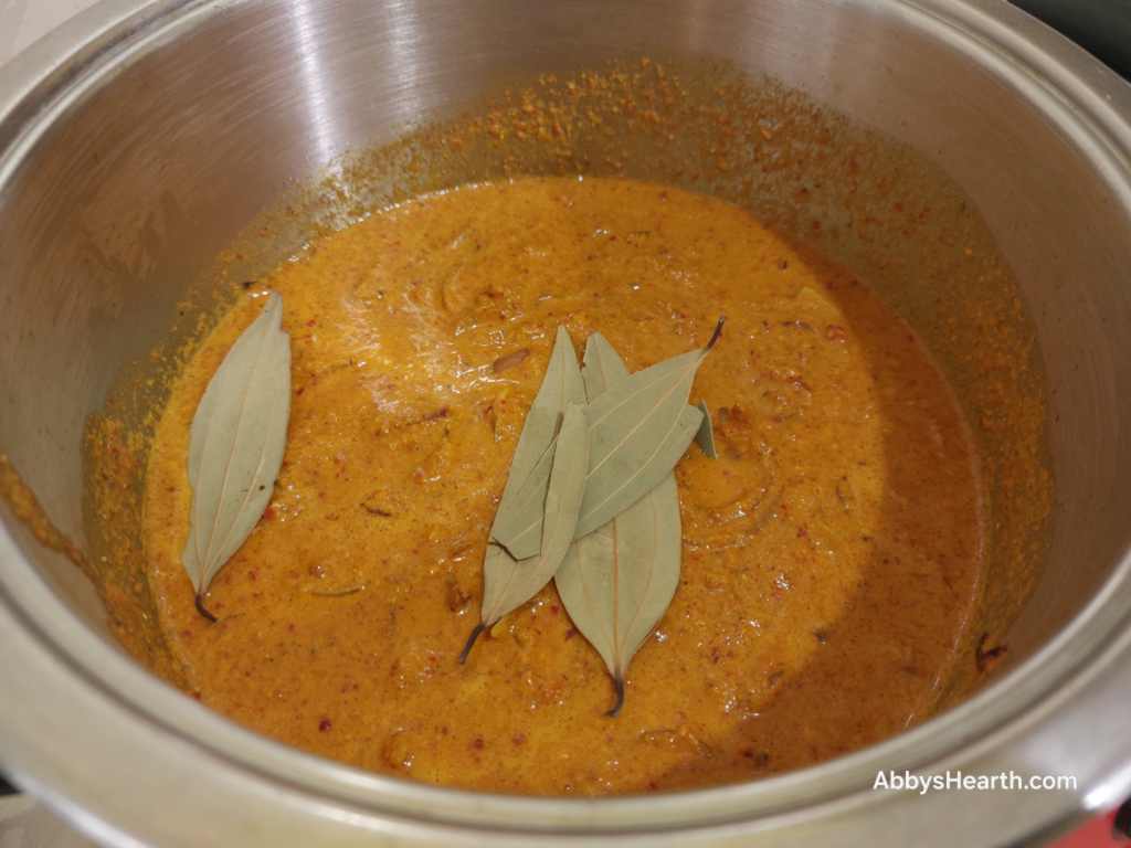 Add bay leaves to the cooked frithad masala.