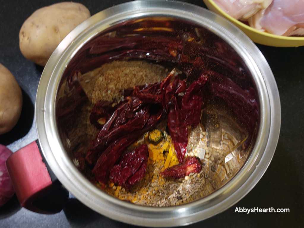Add the soaked chillies to the grinder.