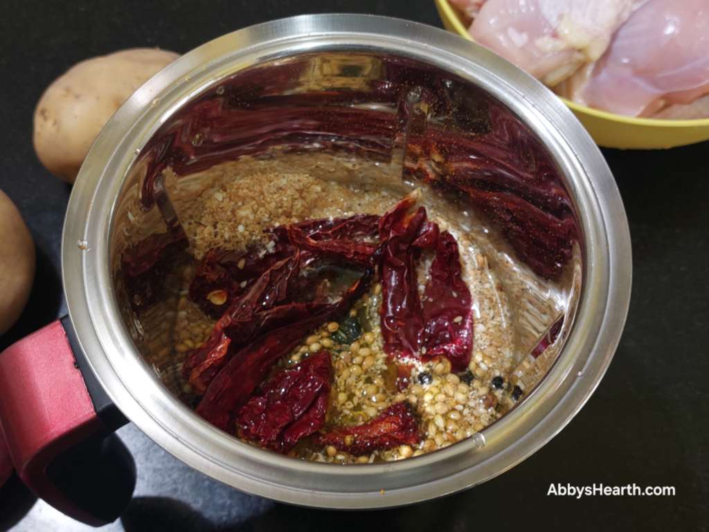 Add enough water to cover the spices and chillies.