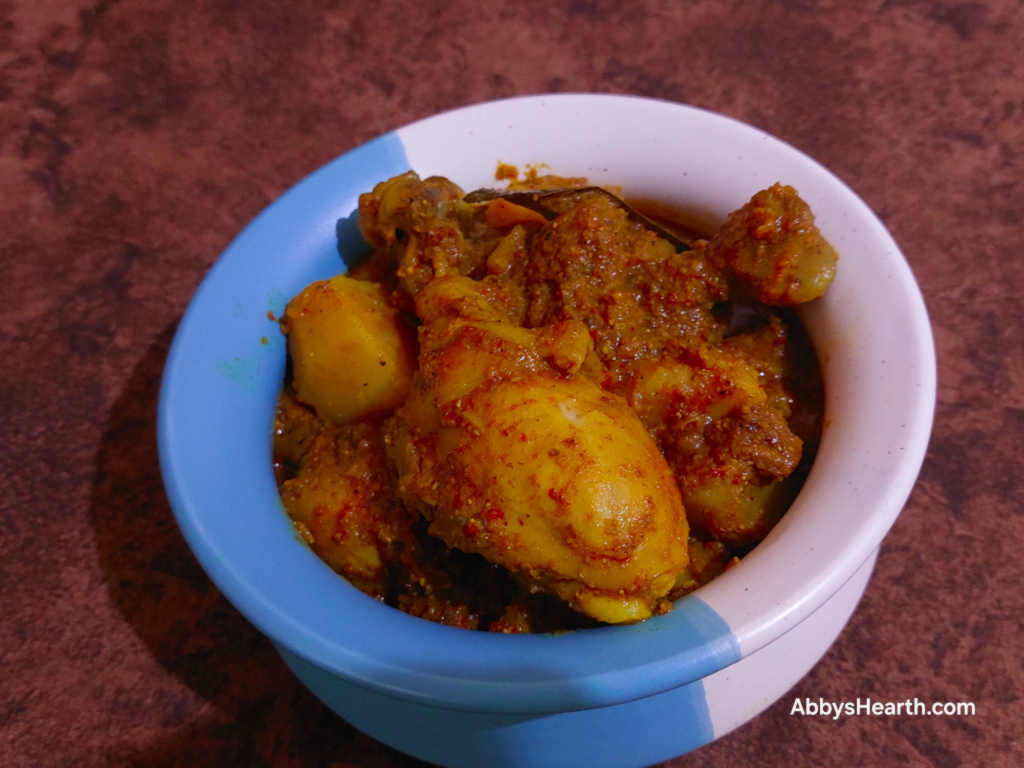 Chicken Frithad curry in a blue and white pot.