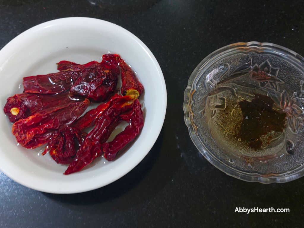 Kashmiri chillies and tamarind in water.