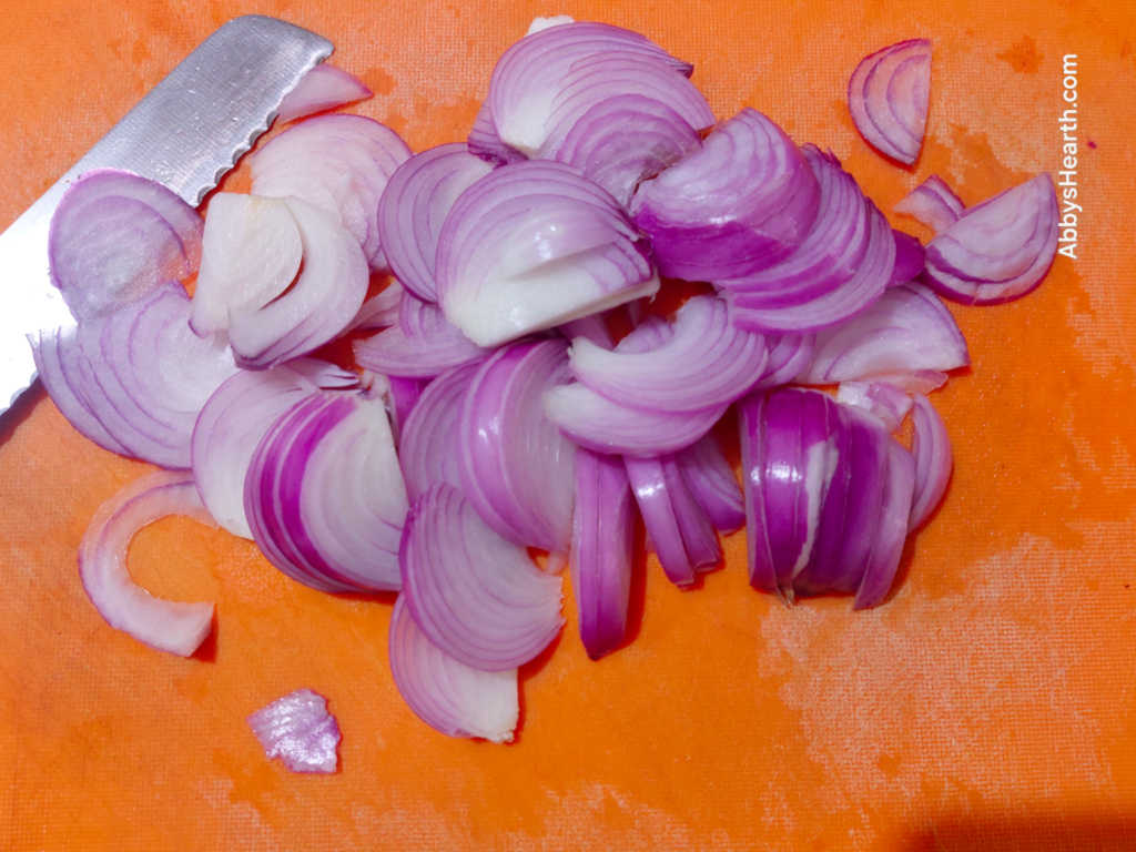 Slice the onions into half moons.
