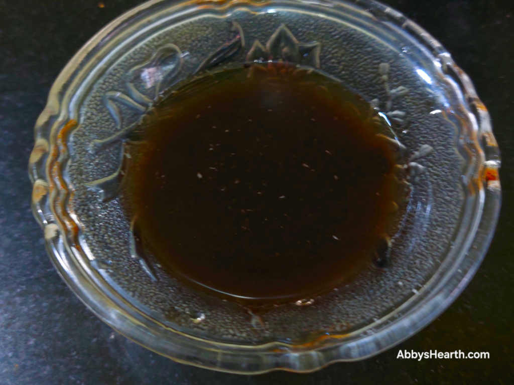 The tamarind pulp melts into the water.