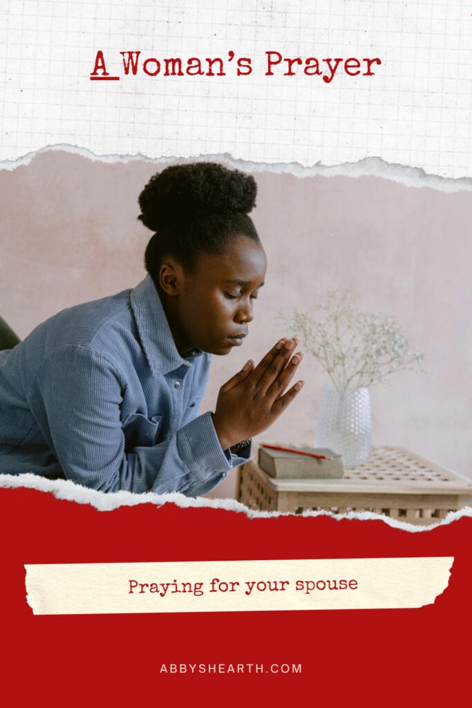 Seated dark skinned woman praying.