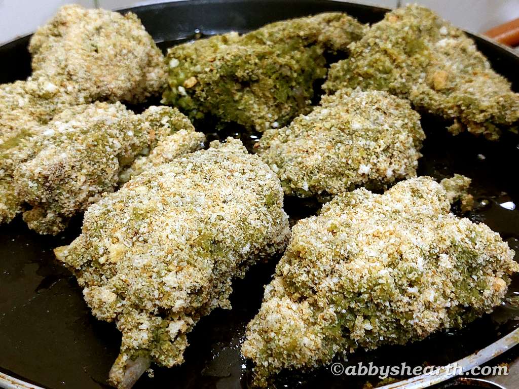Fry the crumbed chops in oil.