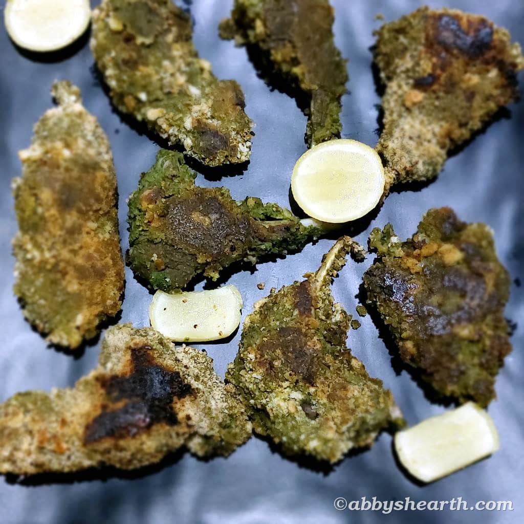 Top view of green mutton chops with sour limes.