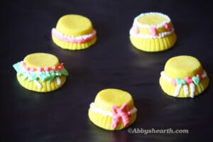 Yellow Marzipan bonnets with royal icing.