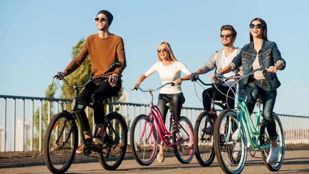 Happy group of people casually cycling.
