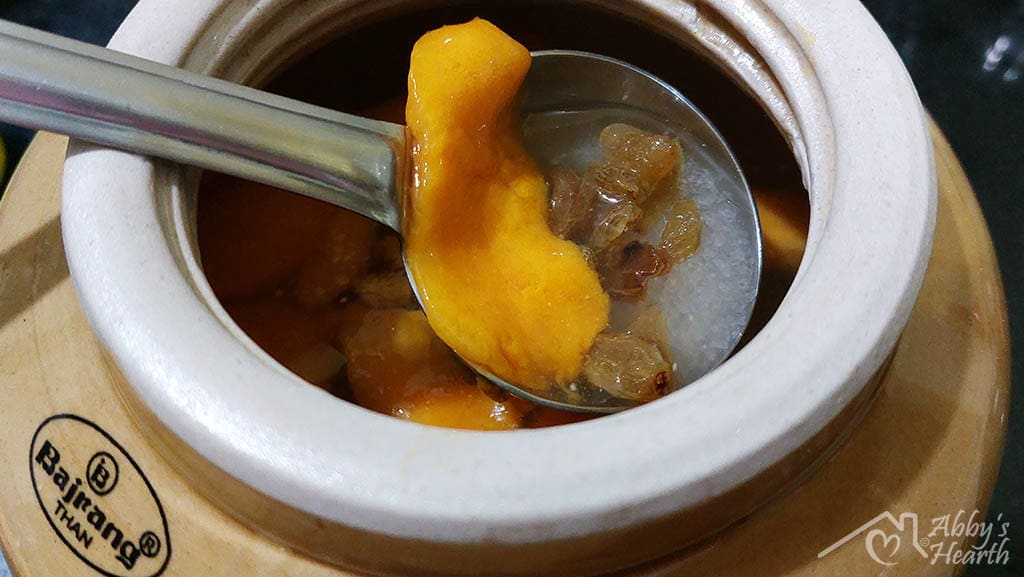 mango, raisins and sugar added with a ladle to the barni.