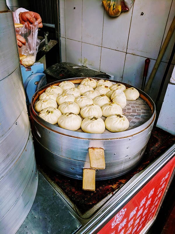 Baozi and Mantou steamed buns on a steaming pot in China.