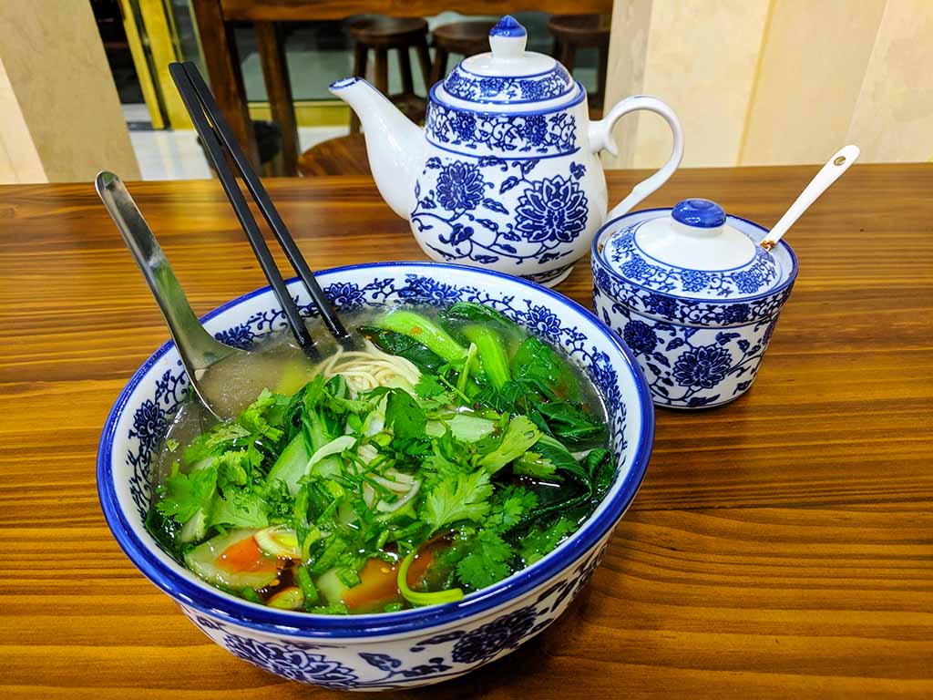 Chinese Lanzhou Lamian in a blue and white bowl.