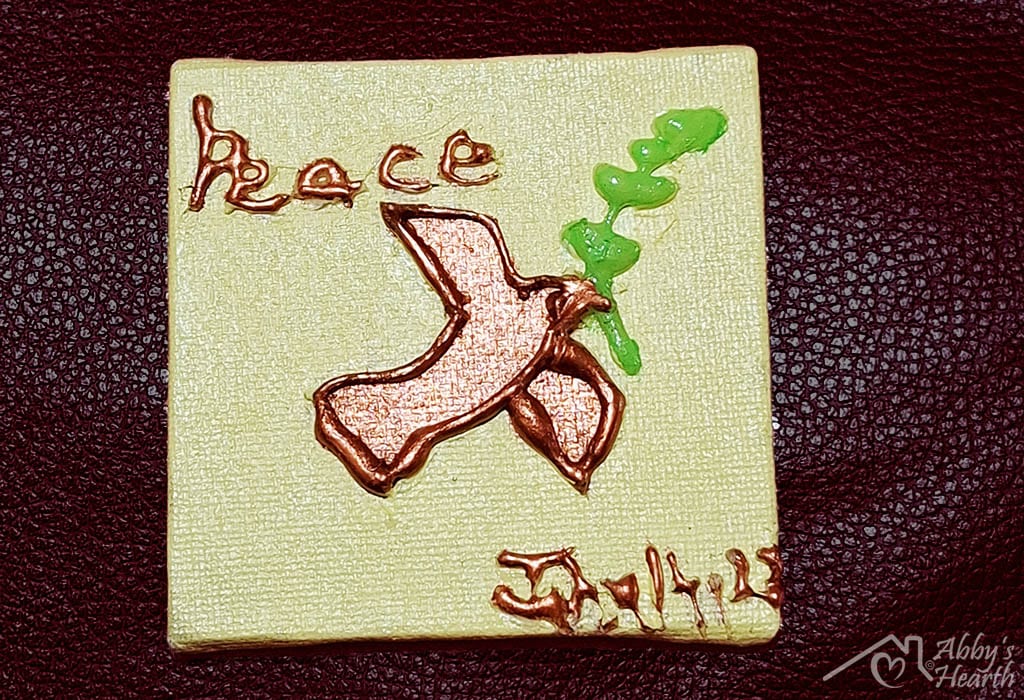 Dove John 1427 peace glue art on yellow canvas.