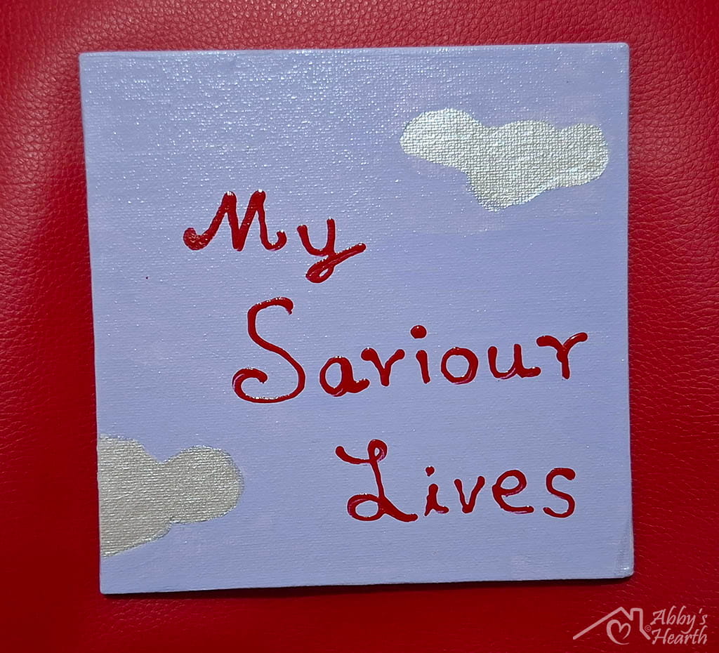 Lavender canvas with silver cloud and "my saviour life" written on it with red.