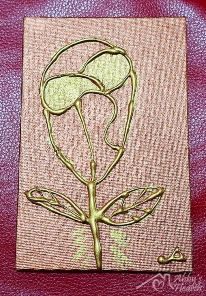 Golden Glue art rose on brown coloured canvas.