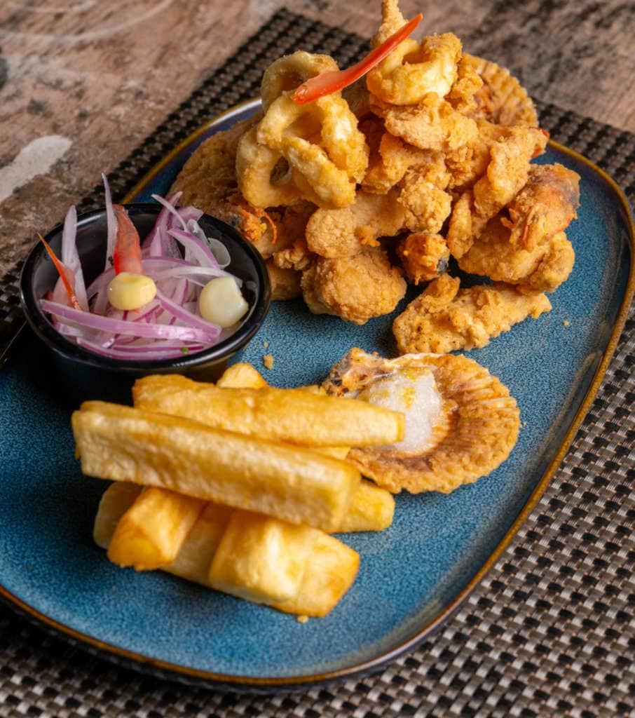 Seafood with fries and onions.