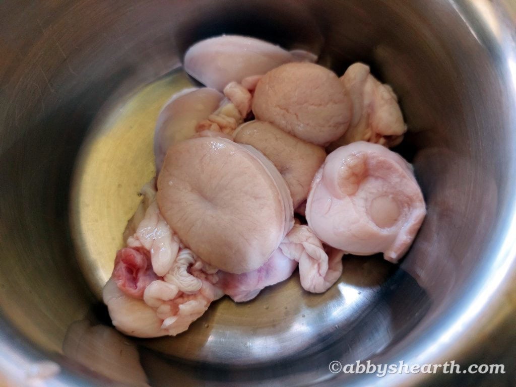 Sliced goat testes in a pot.