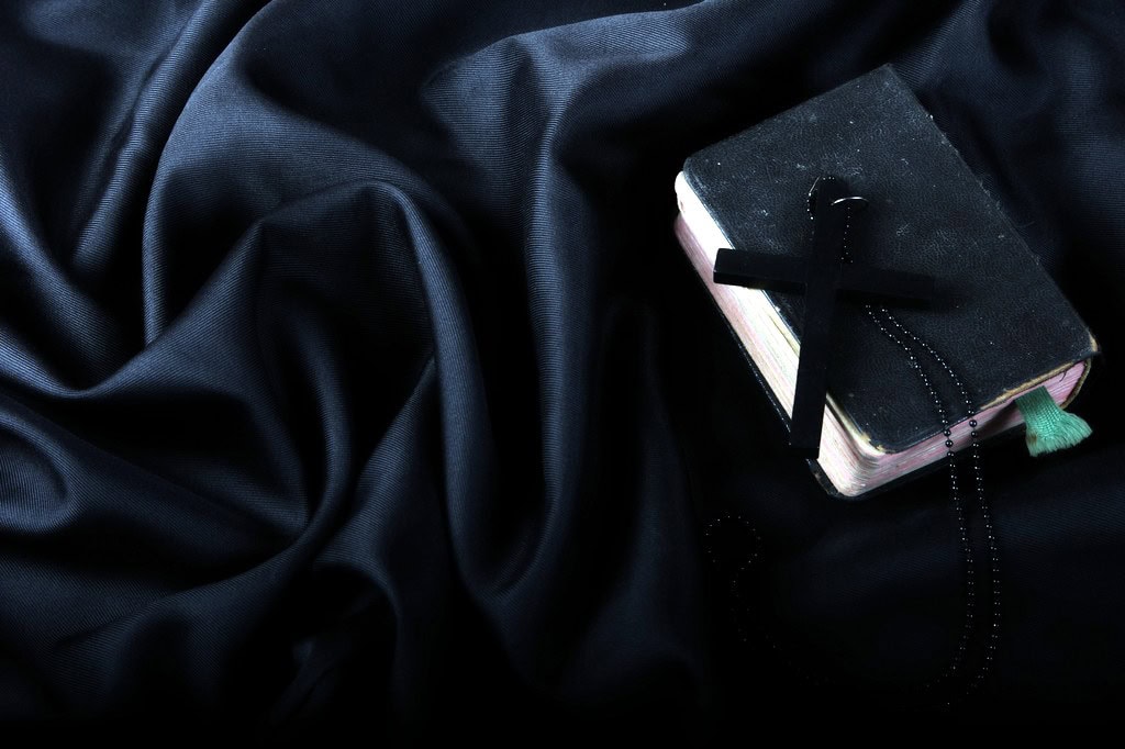 Bible on a dark satin cloth.