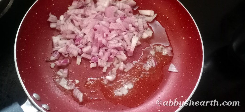 Add the diced onions to the ghee in the pan.