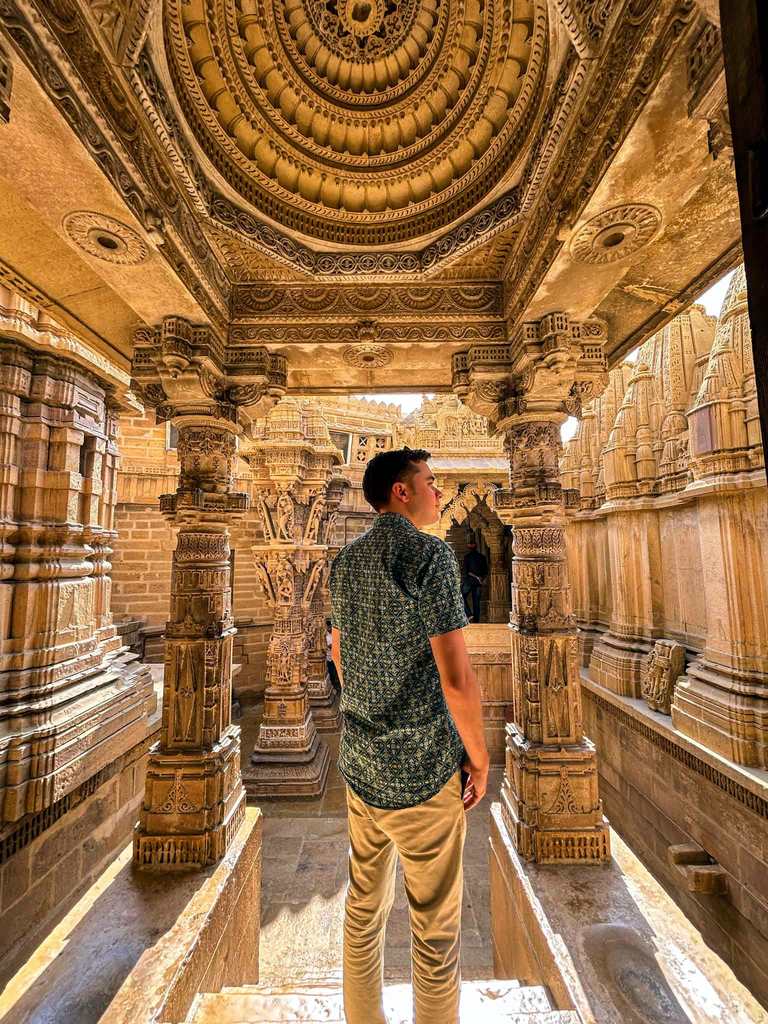 British man standing inside the Jaisalmer Jain Temple.