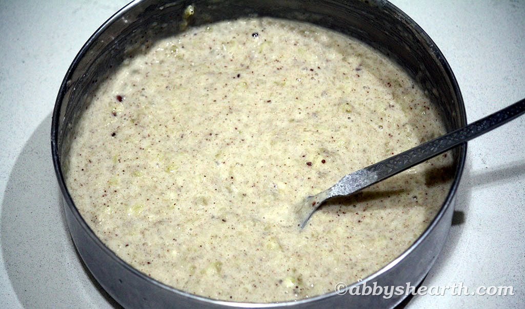 Sugar-free banana fritter batter in a steel bowl — thick and coarse.