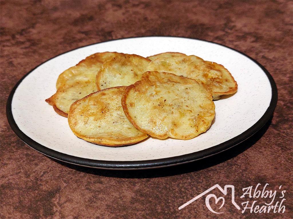 Hot banana fritters in a beige plate.
