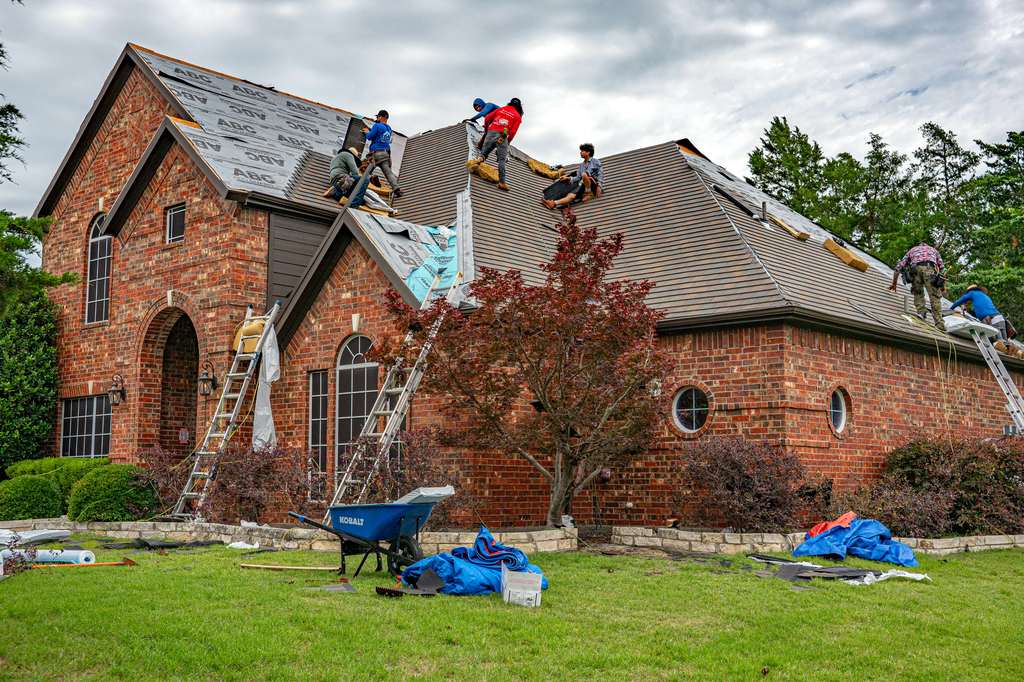 Roofers fixing tiles.