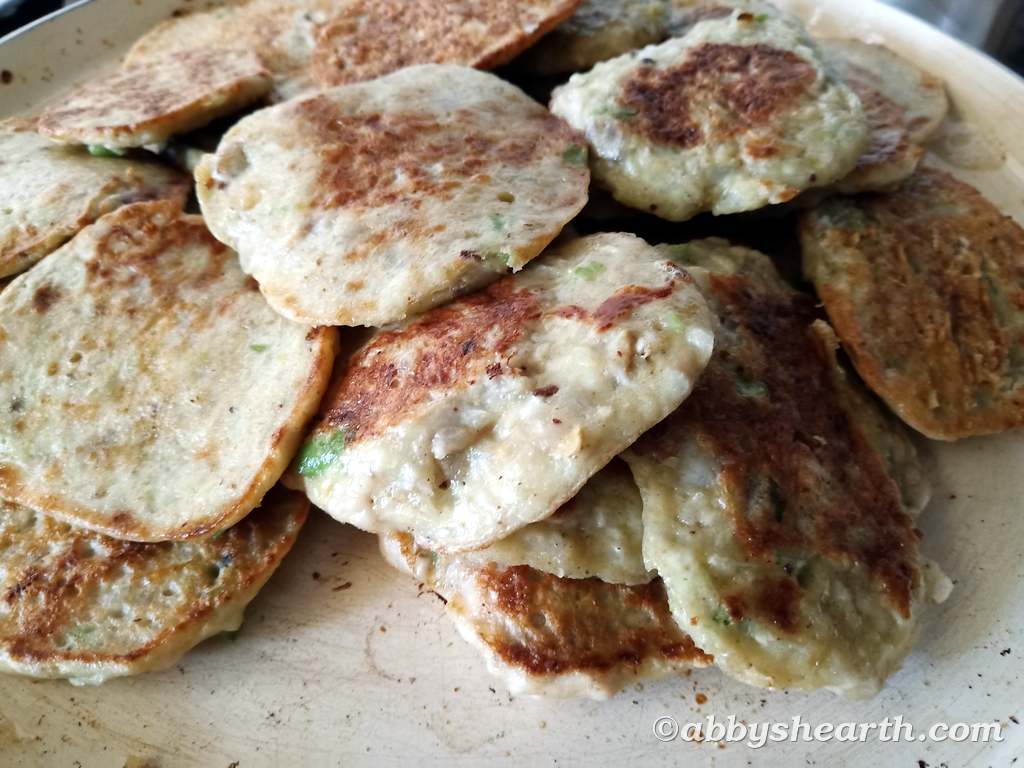 A heap of brain cutlets on a frying pan.