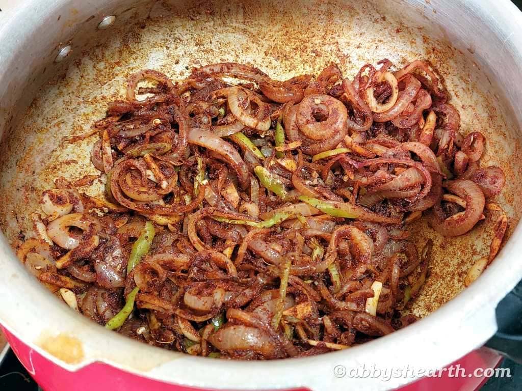 Add bottle masala and garam masala to the onions and mix.