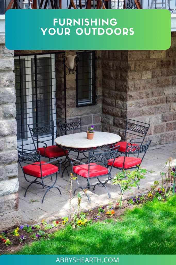 White table and red chairs outside the back door.