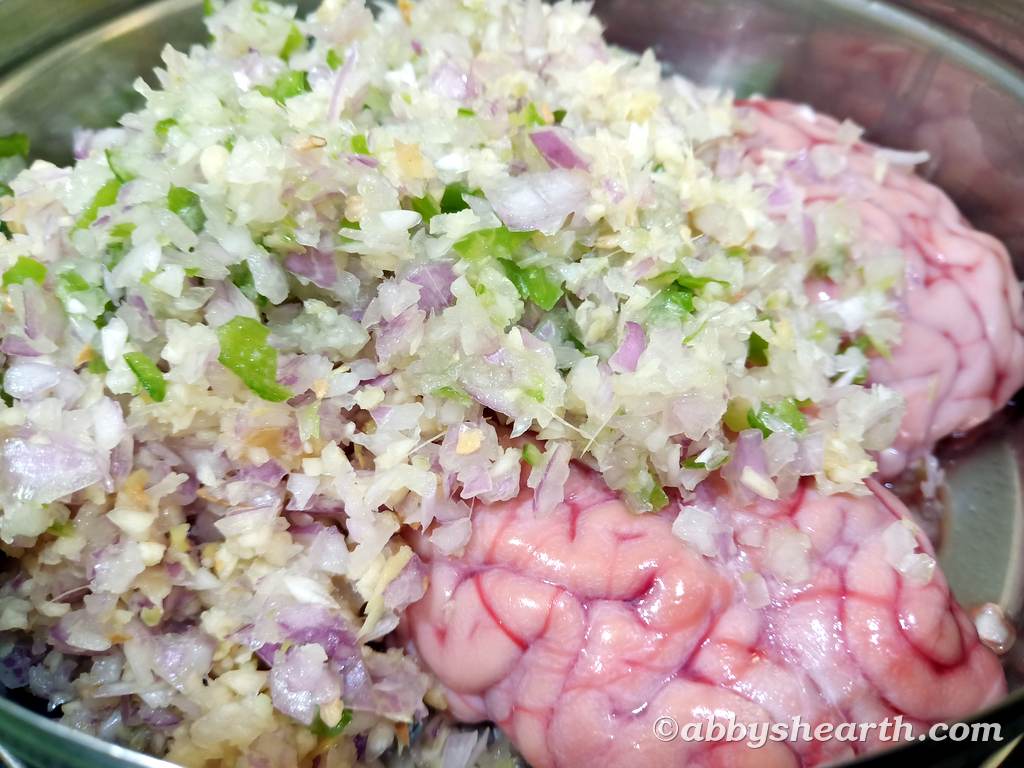 Goat brains in a dish with minced onions and chillies.
