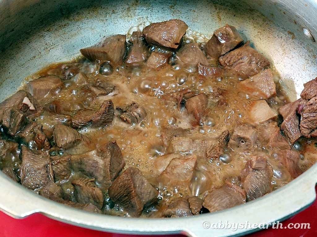 Tongue being browned in the cooker.