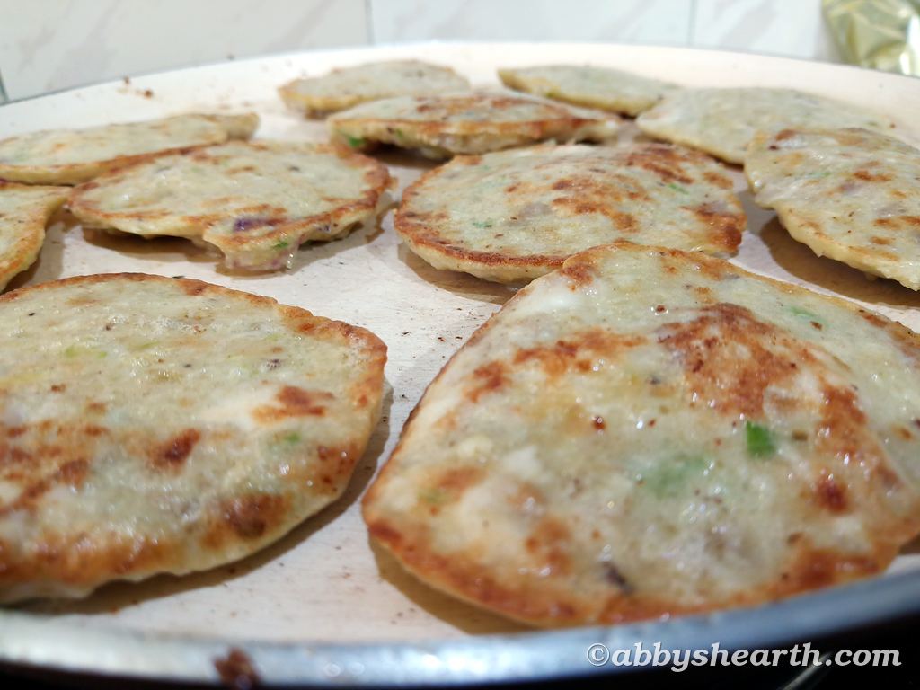 Brain cutlets frying in a pan.