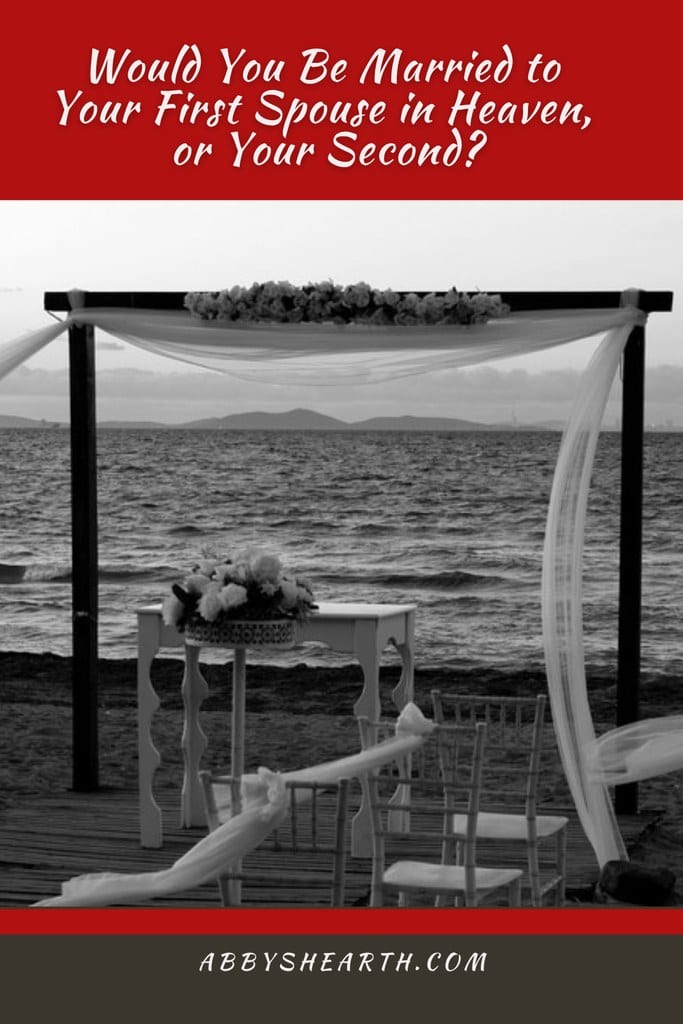 Beach wedding altar with flowers and chairs overlooking the ocean.