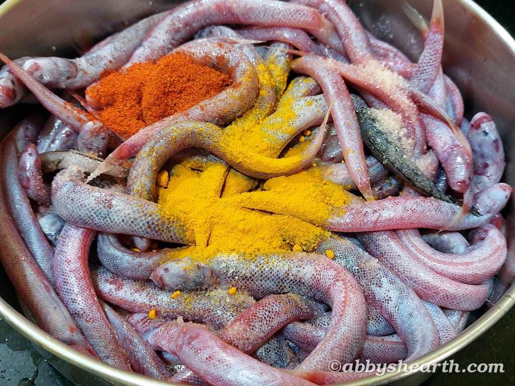 Kalentas with turmeric and paprika spices in a steel bowl for cooking.