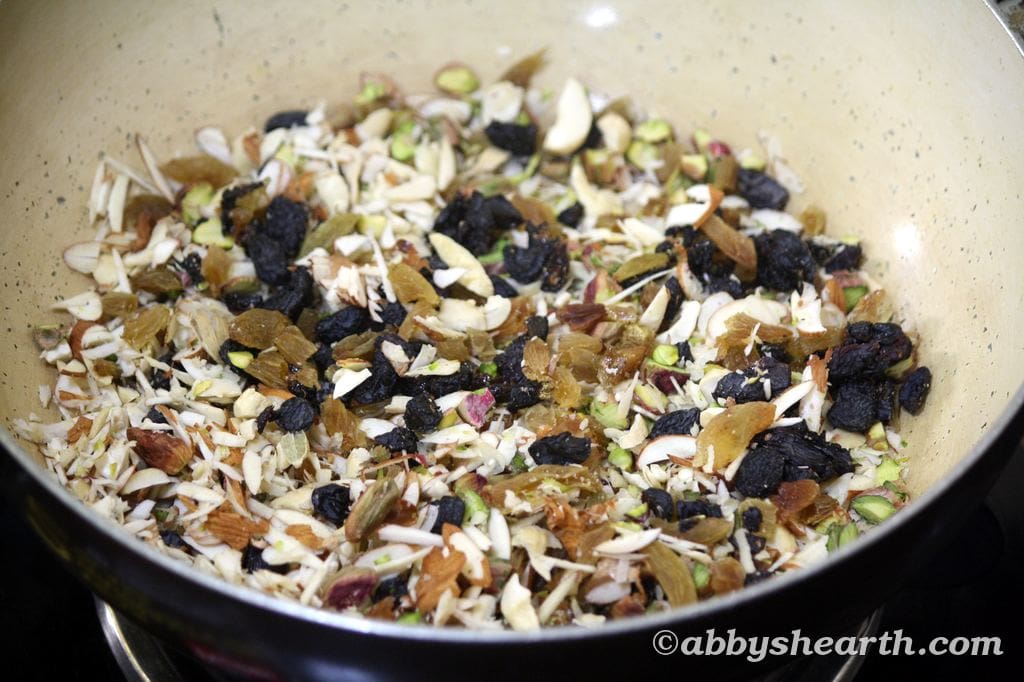 Chopped nuts and raisins being toasted.