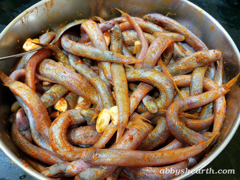 A bowl of kalentas (creek fish) coated with spices.