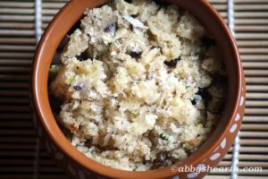 Close-up of soft semolina halwa with nuts served in a bowl on a bamboo mat.