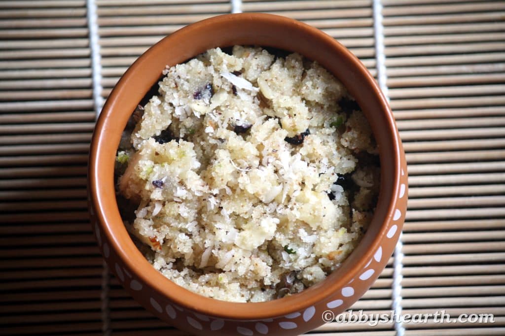Soft semolina halwa with nuts served in a brown bowl on a bamboo mat.