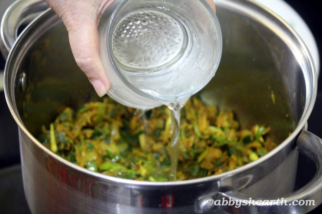 Add water to the cooked spices.