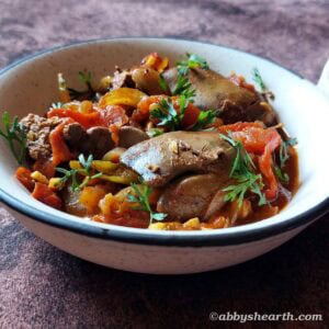 Chicken liver stir fry in a white bowl.