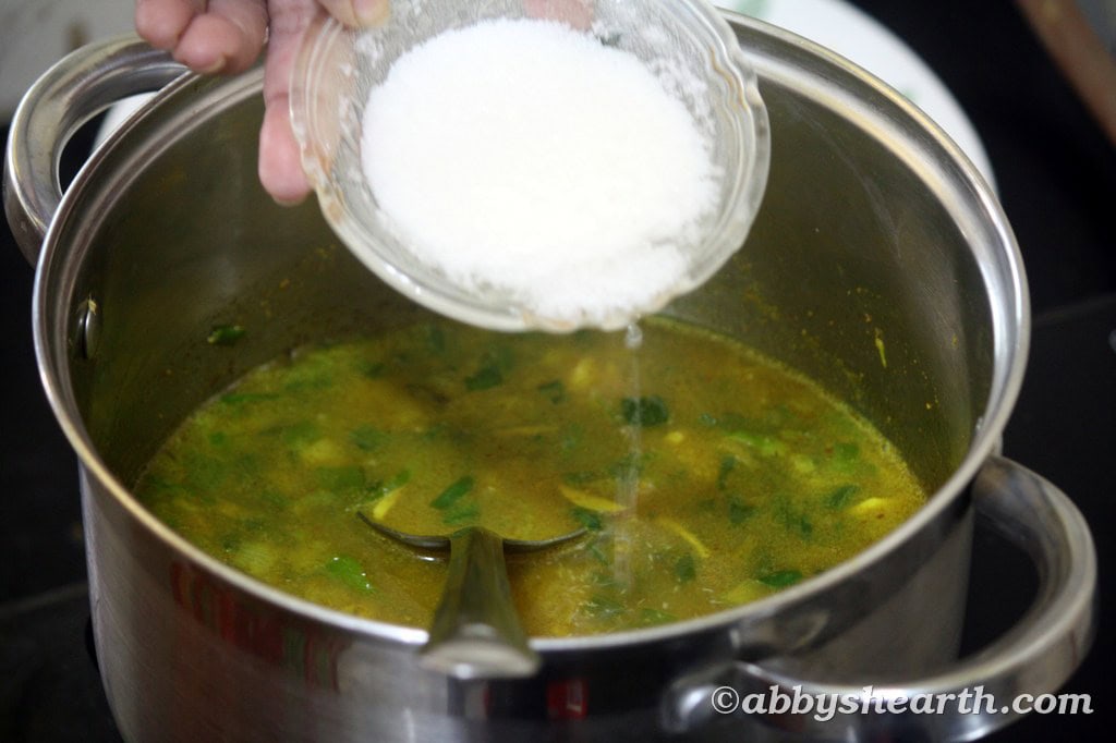 Add the soaking desiccated coconut to the pot.